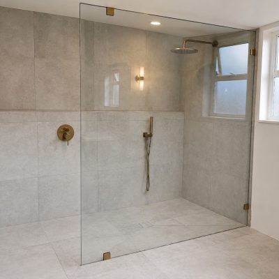 Frameless fixed-panel glass door with premium hardware installed by VanGlaze